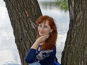 A beautiful mature woman is fondling her genital area