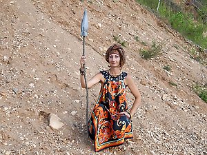 With spear wearing in colorful dress