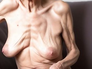 Mature bitch is taking off her dress for a photoshoot